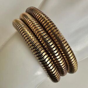 Gold tone triple strand bracelet